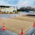 Image montrant une zone de sol dont on a ôté le bitume et dédié à diverses modalités d'essais de renaturation
